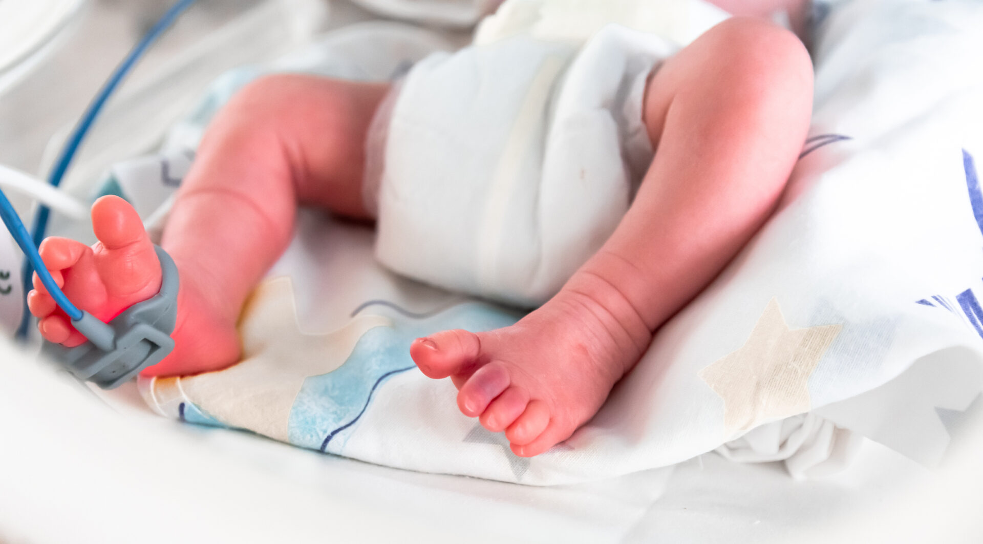 Newborn in hospital incubator