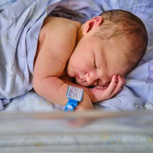 Baby resting under soft blanket