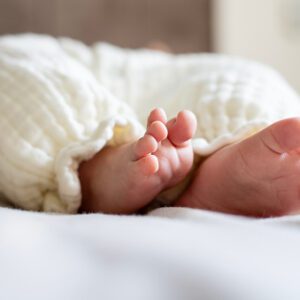 Newborn's feet wrapped in warm fabric