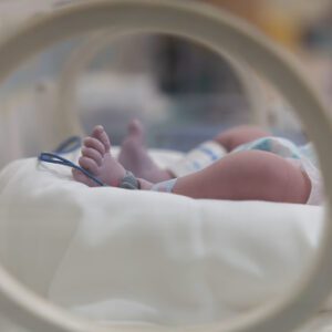 Baby's feet in medical incubator